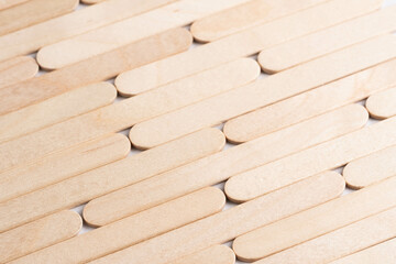 Wooden ice cream sticks on white background. Abstract background and texture for design.