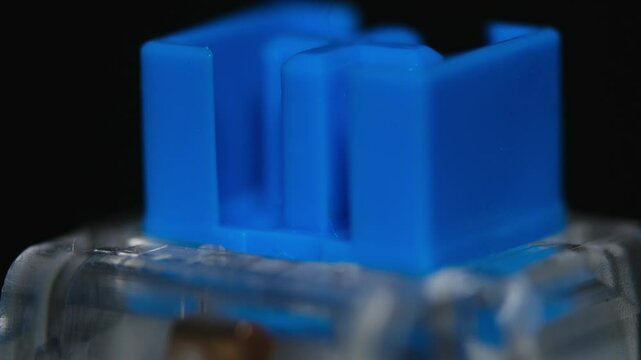 Blue mechanical keyboard key on rotating background in macro shot