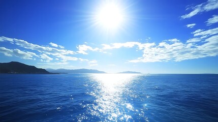 Obraz premium A bright, deep blue sky scattered with small, fluffy clouds, giving a serene and tranquil feeling to the open sky.