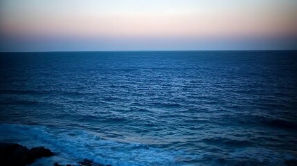 Obraz premium A calm evening sky with a smooth gradient from soft pink to deep blue, creating a serene and beautiful end to the day.