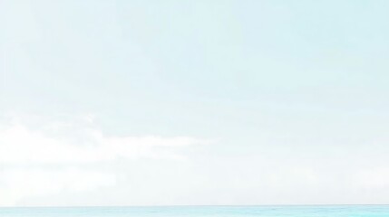 Obraz premium A clear light blue sky with a few fluffy white clouds gently drifting, creating a relaxing and serene outdoor scene.