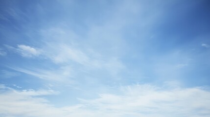 A crisp and clear azure sky with faint wisps of thin clouds drifting lazily, offering a calm and refreshing view of the sky.