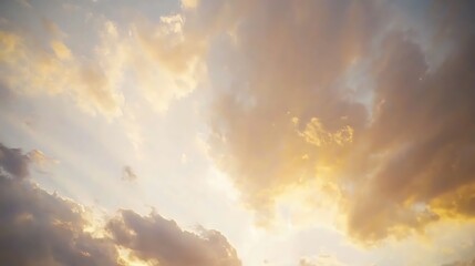 Fototapeta premium A golden-hued sunset sky, with rays of light bouncing off clouds, creating a warm and radiant atmosphere.