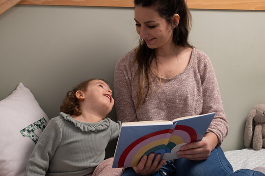 Loving Mother and Daughter Enjoying a Book on World Book Day