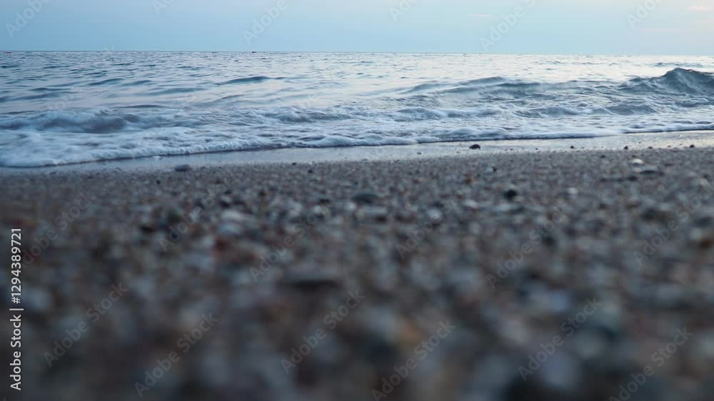 Poster observe tranquil beauty as sun sets on horizon, casting soft hues across ocean. gentle waves ripple 