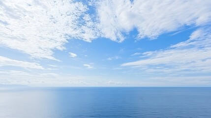 Obraz premium A vast blue sky dotted with small, white clouds, offering a perfect clear day filled with calm and simplicity.
