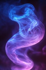 Obraz premium Ethereal smoke swirls in a gradient of blue and purple creating a mesmerizing abstract pattern on dark background