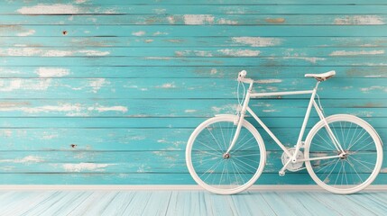 Fototapeta premium A vintage-inspired bicycle mounted on a faded pastel teal wooden wall