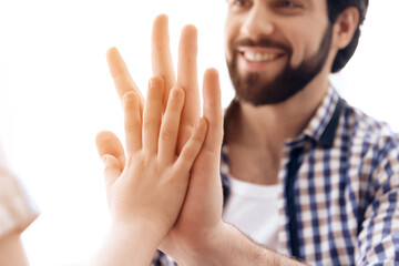 Close up. Joyful father and son give five to each other.