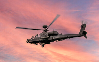 anti tank military helicopter in flight at sunset