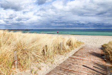 A red wooden boardwalk leading to the beach Baltic Sea in Germany