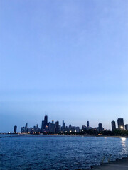 Naklejka premium View of Chicago's Skyline at Dusk from the Lake
