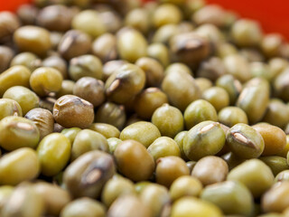 Mung beans on a light background, emphasizing their shape and texture, create a feeling of freshness and naturalness.