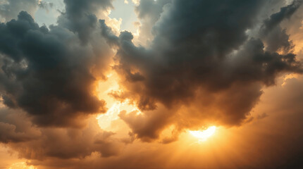 Fototapeta premium Dramatic clouds illuminated by sunset creating a stunning natural light display above a tranquil landscape