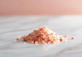 Small pile of pink himalayan salt crystals on white marble surface, showcasing mineral content and geological origins