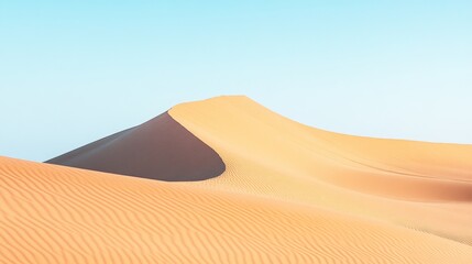 Elegant sand dunes curve gracefully under a clear blue sky, showcasing nature's minimalistic beauty in a tranquil desert landscape.