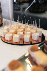 Desserts of macarons, pastries and sweets on a table for waiting guests. Macarons and sweets