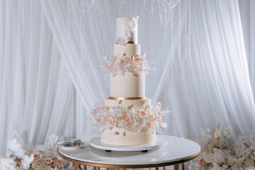 Luxurious white wedding cake decorated with fresh pink roses