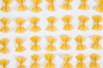Pattern made of farfalle pasta on white background. Top view