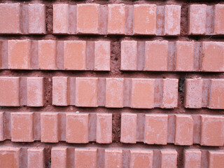 Detail of a wall with special shaped red bricks