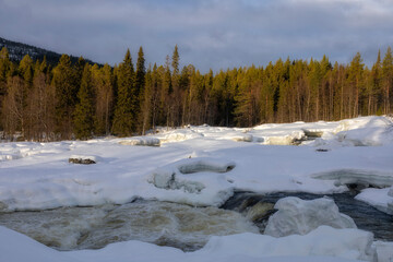 Winter landscape with a waterfall and snow. Russia, Karelia