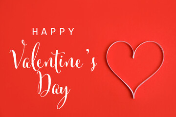 Happy Valentine's day card with heart made of ribbon on red background, top view