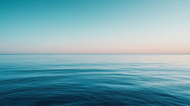 The horizon blends seamlessly into calm ocean waves under a tranquil sky, capturing an infinite expanse of peace and natural beauty.
