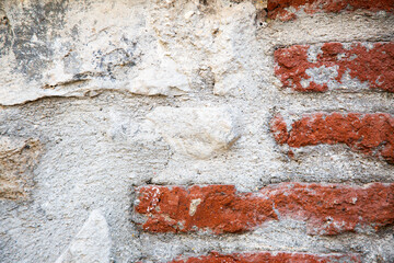 This is a closeup view photograph of a brick wall featuring red bricks