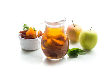 Dried fruit compote with apples and mint, isolated on white background