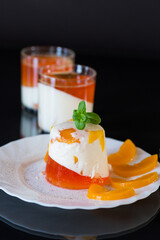 Panna cotta dessert with fruit jelly and mint