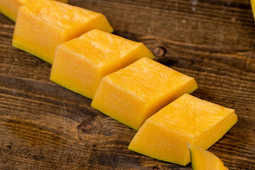 freshly cut orange pumpkin with cooking seeds