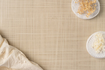 Fabric and ribbons with flowers on the table. Flat lay, top view. Copy space