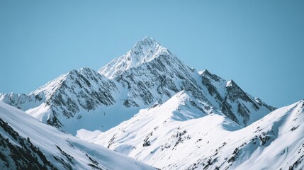Fototapeta premium Majestic snow-covered peaks stand proudly against a backdrop of clear blue sky, embodying natural grandeur.