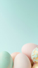 Easter eggs in pastel colors with gold patterns on light blue background