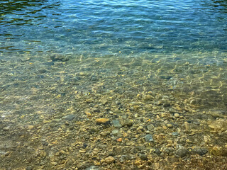 Crystal clear sea with pebbles at the bottom.
