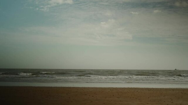 Beach waves on an empty beach with soft daylight