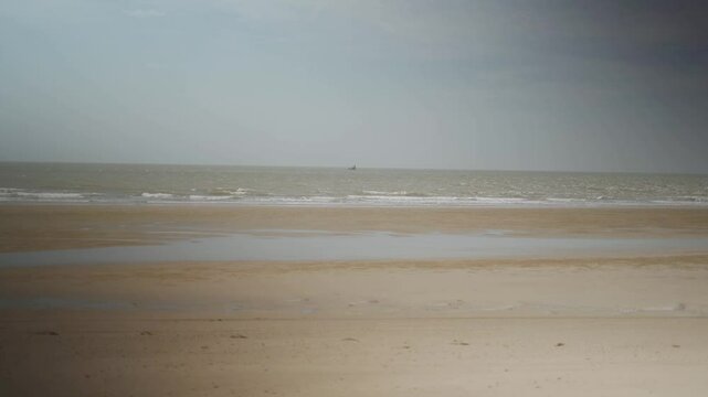 Beach waves on an empty beach with soft daylight