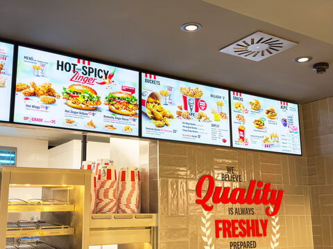 Fast food restaurant menu display with fried chicken and burgers