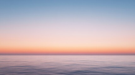 Obraz premium A serene ocean scene reflects a pastel sky, where the horizon blurs seamlessly into soft hues, creating a tranquil and infinite seascape.