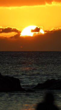 Beautiful sunset with big sun in hawaii with ocean