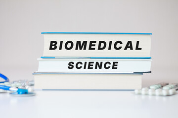 Obraz premium Biomedical science inscription medical scientific books background