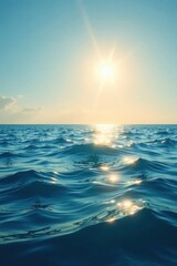 Obraz premium Serene Ocean Surface at Sunset Sunbeams Dancing on the Water's Gentle Waves
