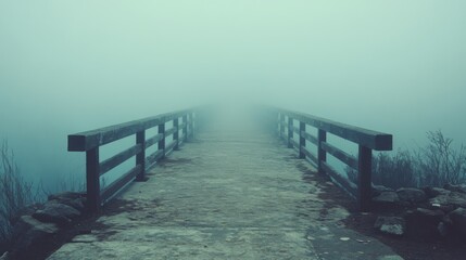 A bridge fades into the thick mist, creating an eerie and mysterious ambiance in a foggy landscape.