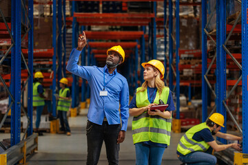 Warehouse manager having a conversation with a female worker