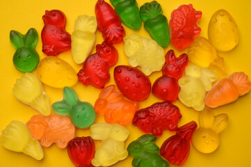 Playful Easter candy composition featuring colorful gummy rabbits, chicks, and eggs . A cheerful image for seasonal designs and holiday promotions.