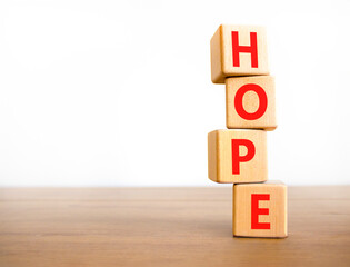 Hope symbol. Concept word Hope on beautiful wooden blocks. Beautiful wooden table white background. Business, lifestyle, support and hope concept. Copy space.
