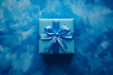 A blue gift box with a blue ribbon tied around it