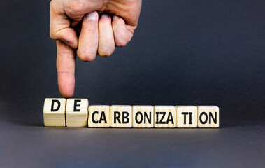 Decarbonization or carbonization symbol. Concept words Decarbonization or Carbonization on wooden blocks. Beautiful grey background. Business decarbonization or carbonization concept. Copy space.