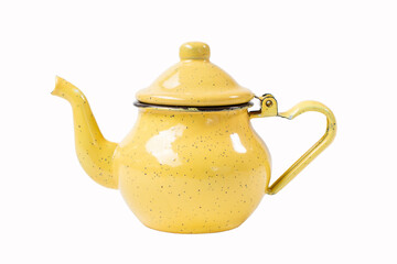 vintage enamel yellow teapot with spotted pattern with curved spout and handle resembling heart shape isolated on white background