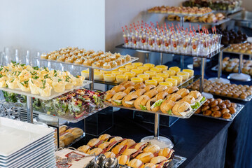 catering table with food, snacks and desserts